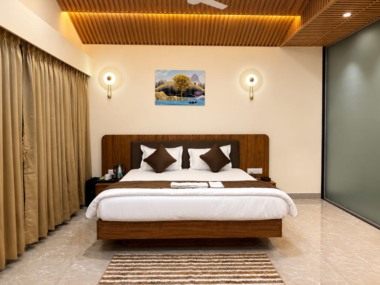 Royal Suite king bed beneath the timber-slat ceiling with wall sconces
